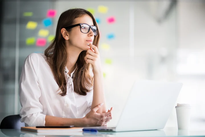 AI Marketing for Beginners: 7 Steps to Use for Your Business (No Coding Needed) 4 Image shows a woman thinking how to use AI marketing