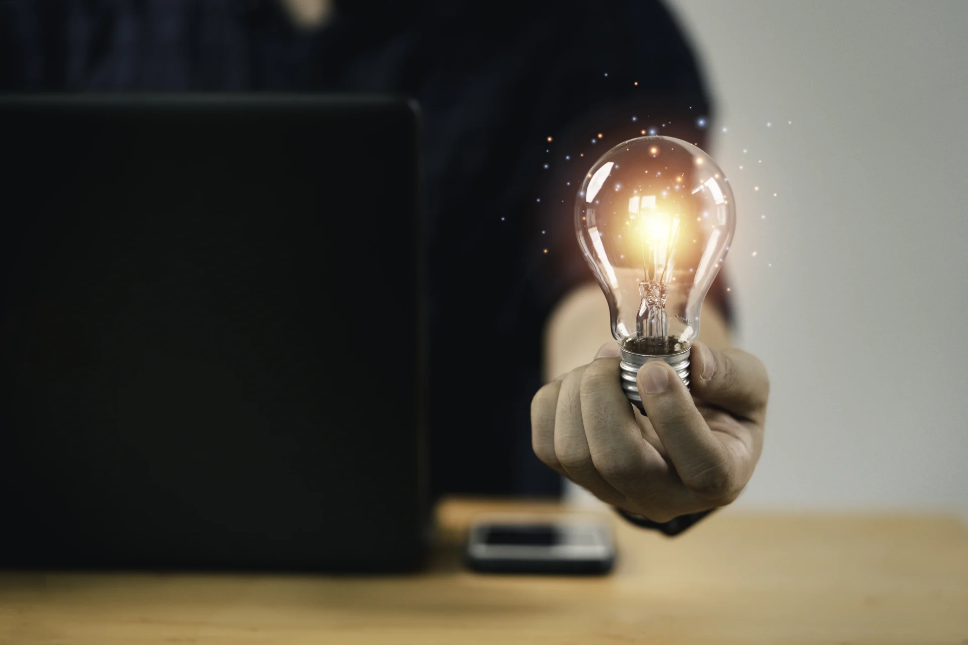 Image shows a man holding a spotlight as a symbol of how to combine AI and human creativity